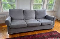 Front view of grey three-seat sofa