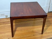 Full view of square rosewood side table showing top and legs