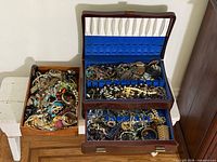 Two boxes of mixed costume jewellery including wooden jewellery chest and open box