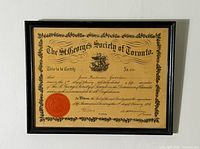 Full view of framed certificate showing text, seal, frame