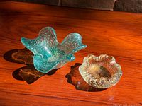 Both Murano glass bowls side by side on wood surface