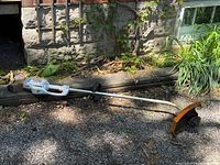 Full view of Stihl FSE 60 trimmer showing curved shaft, loop handle and guard