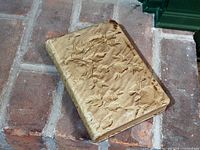 Front cover view showing embossed floral cloth