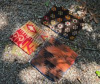 All three cushion covers displayed outdoors on gravel
