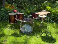 Full front view of complete TRAK drum kit outdoors