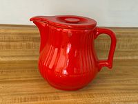 Full view of red ribbed Hall China coffee pot on counter