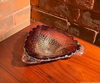 Top view of red Murano glass bowl showing bullicante bubbles and scalloped rim