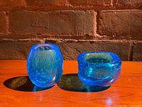 Front view of both cobalt blue bullicante glass pieces