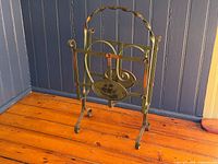 Full view of wrought iron magazine rack showing overall design and finish