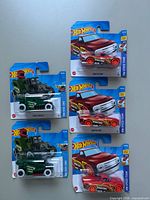 Front view showing five carded Hot Wheels models (3 Draftnator, 2 Pixel Shaker)