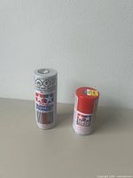 Both Tamiya aerosol cans standing upright