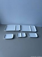 Two large divided plates and three small dishes laid out