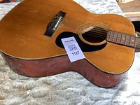 Full body front showing natural top, pickguard, bridge and QR tag