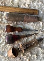 All four tools with ruler for scale