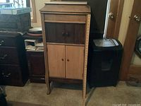 Front view of closed wooden phonograph cabinet