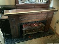 Full view of electric fireplace mantel with insert showing overall design and scale