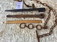 All hardware pieces laid out beside ruler for scale