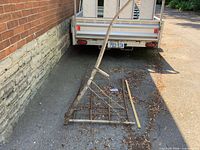 Full view of hay rake leaning against trailer, shows overall size and structure