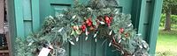 close-up of top section with pine, red berries and apples