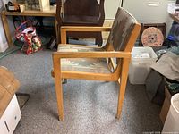 Side view of armchair showing wood frame, arms, patterned fabric