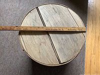 Top view showing planked lid and measuring stick for diameter