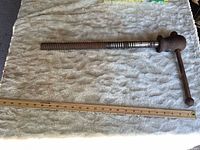 Full length view of bench vise spindle beside 24 in ruler