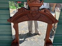 Close view of carved crest and upper frame