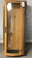 Front view of cabinet showing glass door and spindle trim