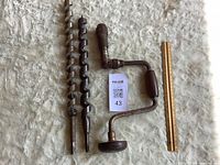 Brace and two auger bits with ruler for scale