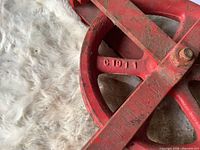Close-up of Western Block name and model cast into red pulley frame