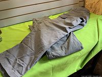 Both pairs of gray cargo pants on table