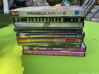 Stack of eight cased DVDs showing spines