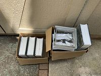 Two cardboard boxes holding eight new glass blocks