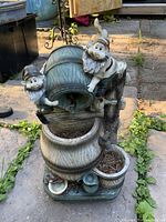 Full view of resin gnome fountain showing both figures, barrel and urn structure