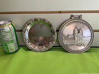 Front view showing plate, plaque, and soda can for scale