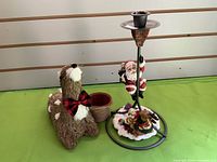 Wide shot showing Santa candle holder and reindeer planter with pot