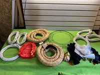 Overview showing straw wreath forms, wire wreath frame, white rope coils and red plastic mold