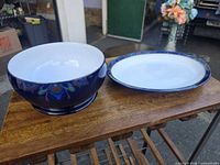 Footed bowl and oval platter on table