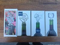 Front view of four Mikasa stopper boxes showing design images