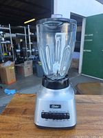 Full view of Oster blender showing base, glass jar, lid