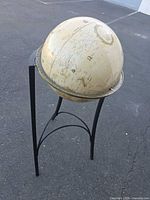 Full view of globe on metal stand