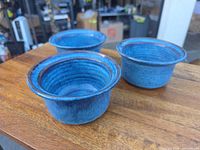 Three blue turquoise stoneware ramekins, top angle