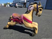 full side view of wooden carousel horse showing overall form and colors