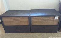 Front view of both plywood cabinets showing woven rattan fronts and knobs