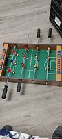 small tabletop foosball game wood frame green field