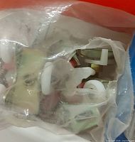 Bag of assorted plastic rollers and hardware