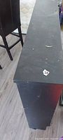 Top view of black headboard showing surface wear