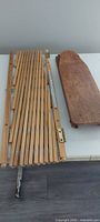 iron board panel and collapsed wooden gate laid on table