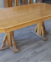 Full view of oak dining table assembled with leaf inserted