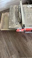 Top view of metal table surface with rip fence and miter gauge slot